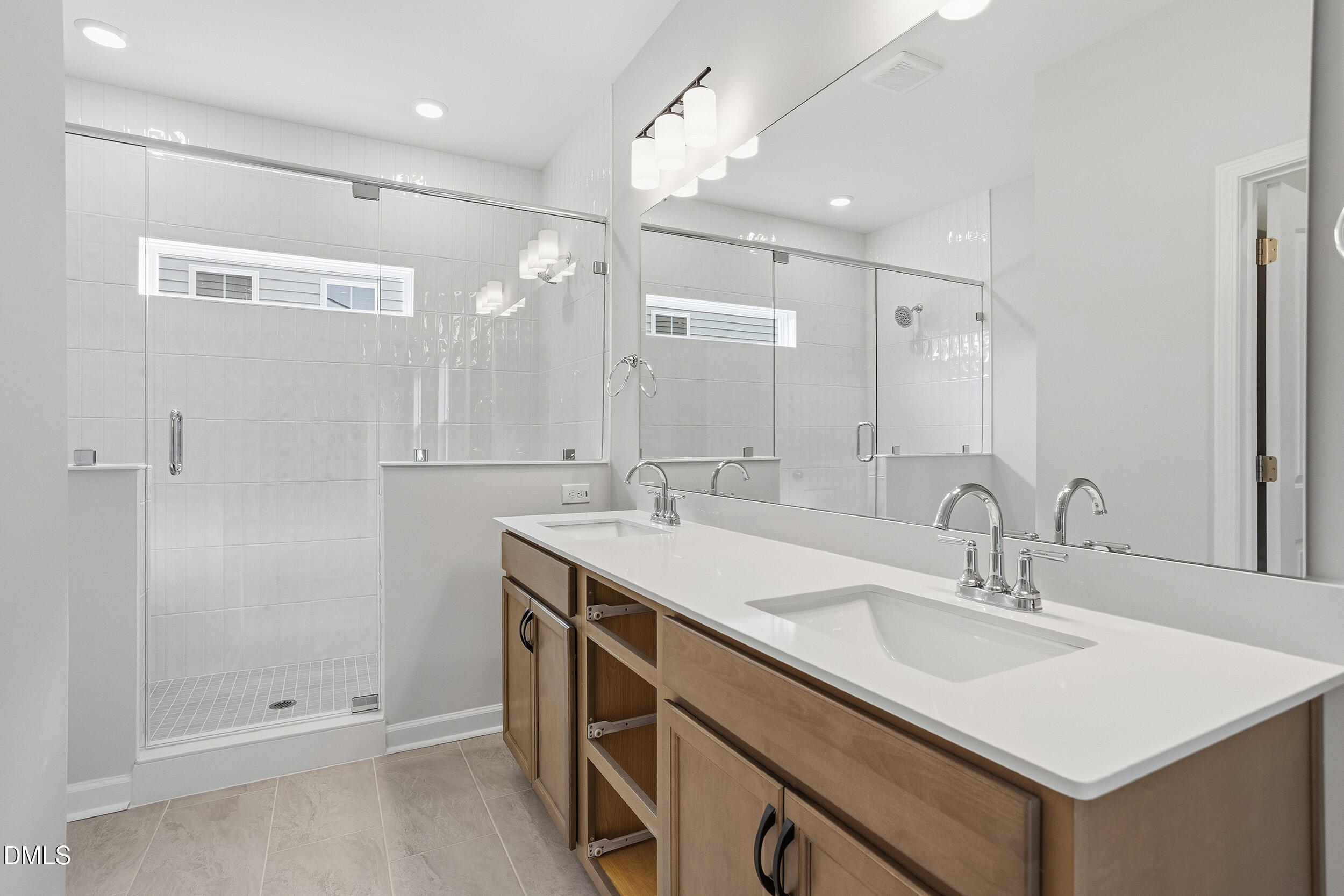 288 Meadowbark Bend, Unit 37 Garner, NC 27529 - Photo 22 of 50 a bathroom with a sink double vanity and shower