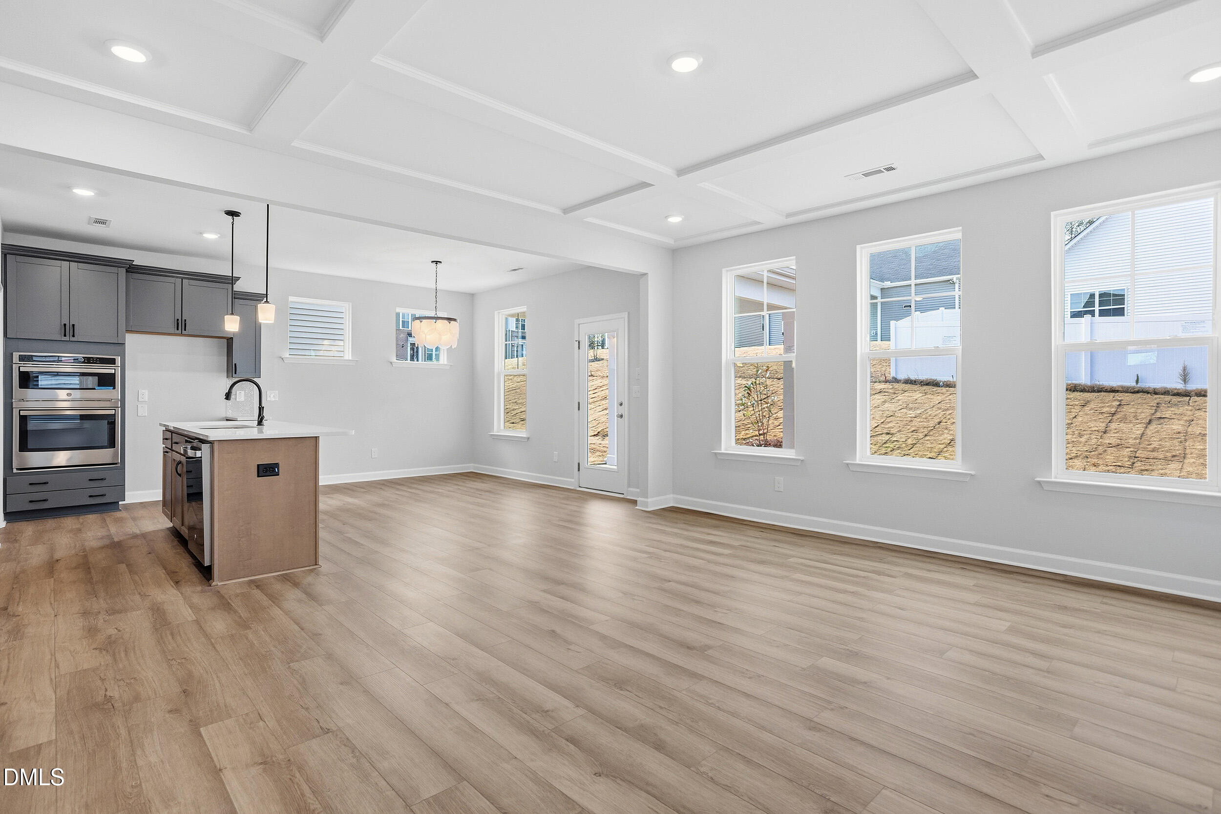 288 Meadowbark Bend, Unit 37 Garner, NC 27529 - Photo 6 of 50 a view of a kitchen with stainless steel appliances wooden floor and large windows