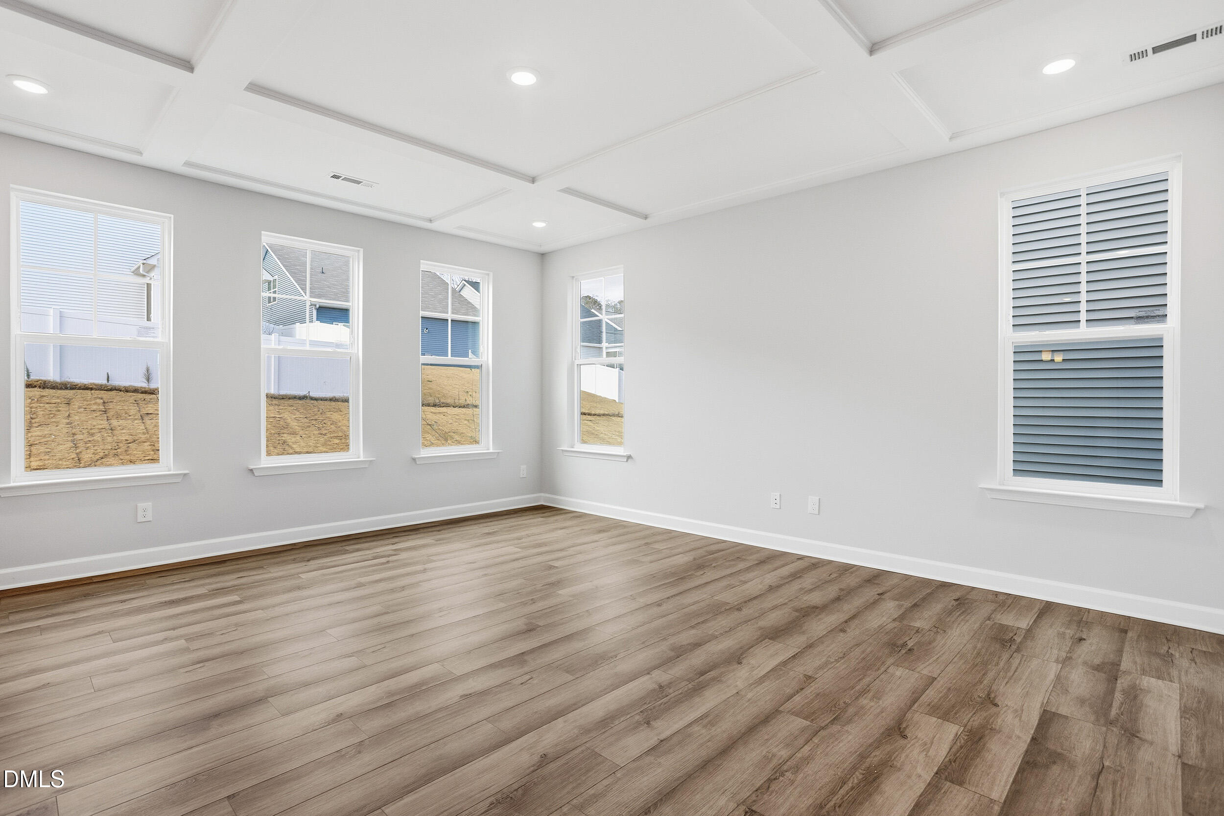 288 Meadowbark Bend, Unit 37 Garner, NC 27529 - Photo 8 of 50 an empty room with wooden floor and windows