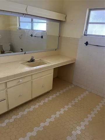 a bathroom with a sink a toilet and bathtub