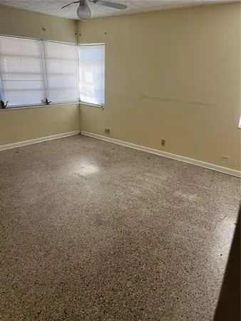 an empty room with windows and closet