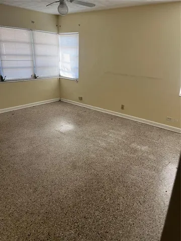 an empty room with windows and closet