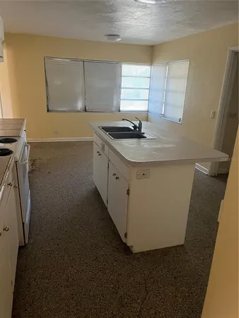a kitchen with a sink and cabinets