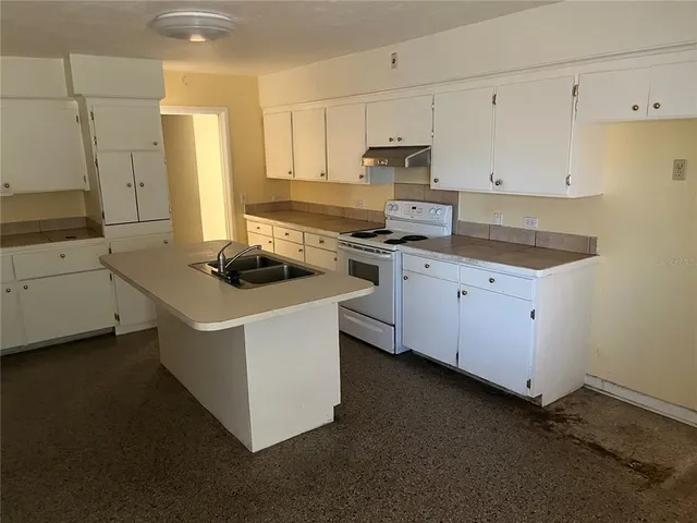 a kitchen that has a sink and a stove in it