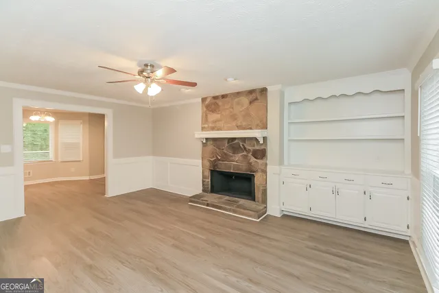 wooden floor chandelier and a fireplace