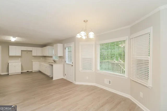 a view of a kitchen with a sink cabinets and a large window