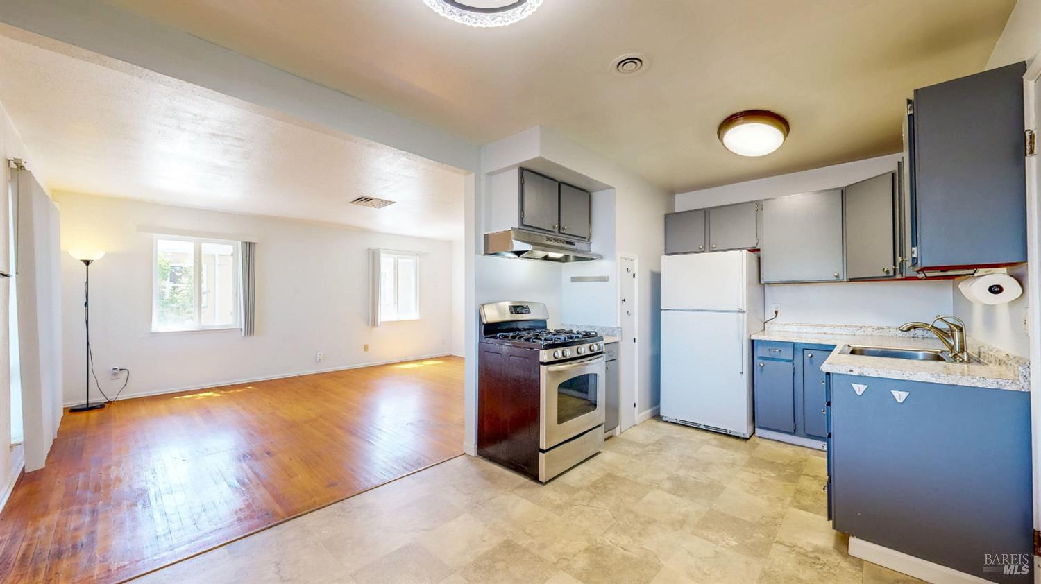 809 Maple Avenue Vallejo, CA 94591 - Photo 14 of 46 a kitchen with granite countertop a refrigerator and a stove top oven
