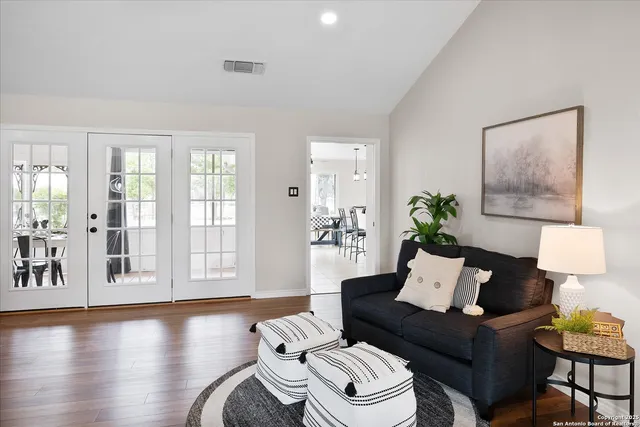 a kitchen with a table chairs sink and cabinets