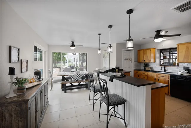 a kitchen with stainless steel appliances kitchen island granite countertop a sink a stove and refrigerator
