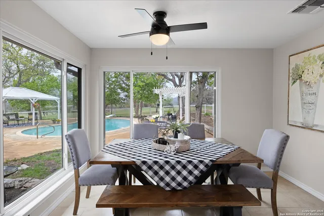 a bedroom with a large bed a chandelier and windows