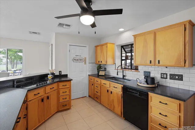a kitchen with a sink and a stove top oven