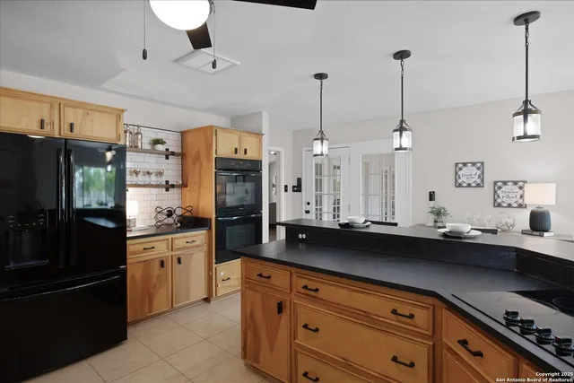 a bathroom with a sink a mirror a glass door a shower and vanity