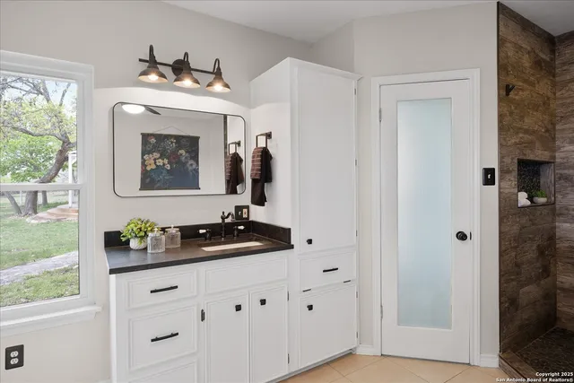 a view of kitchen with stainless steel appliances granite countertop a sink and dishwasher a stove with wooden floor