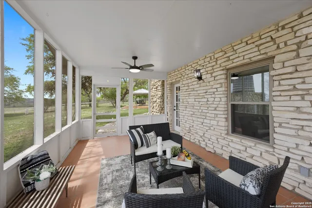 a view of a patio with a table chairs and a backyard