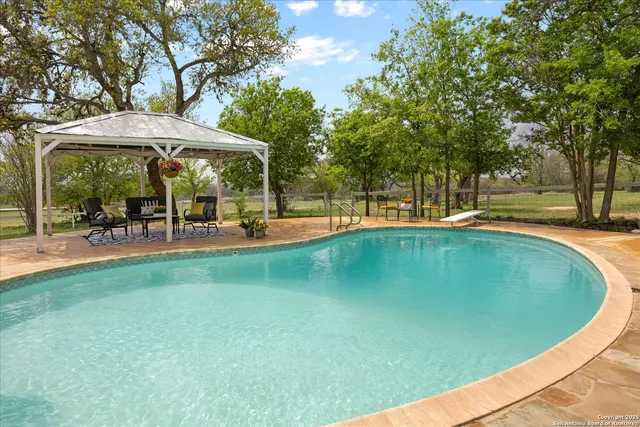 a living room with furniture a chandelier and a window