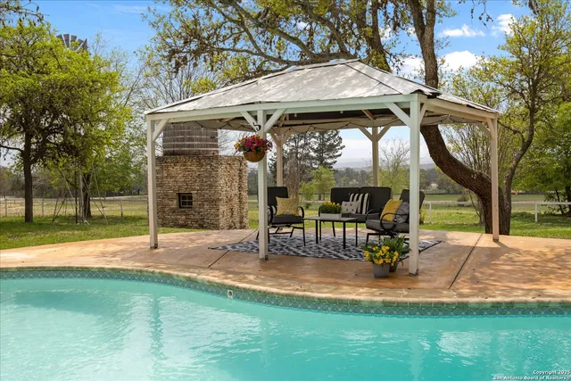a bedroom with a large bed couch and a window