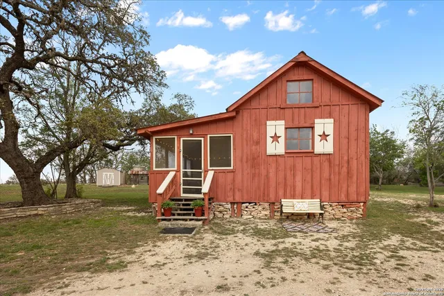 a backyard of a house with table and chairs