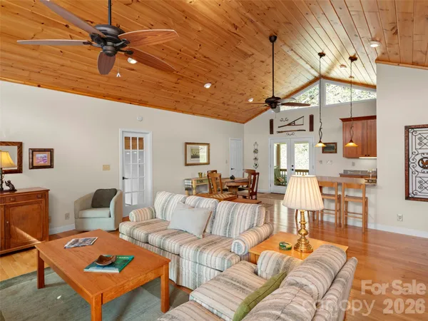 a living room with furniture a ceiling fan and a rug