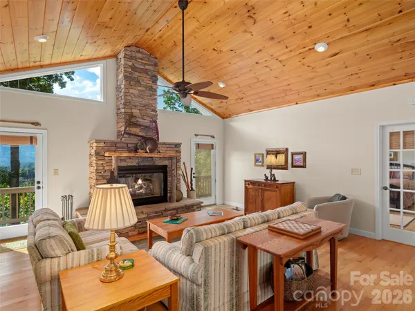 a living room with furniture a fireplace and a table