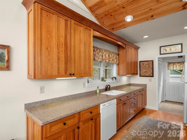 a kitchen that has a sink and a stove in it