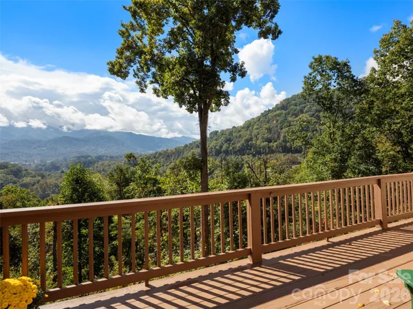 a balcony with wooden floor and fence