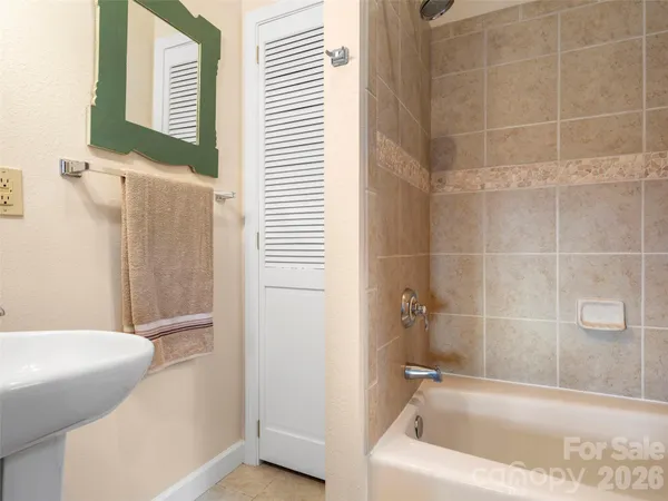a bath tub sitting next to a white sink