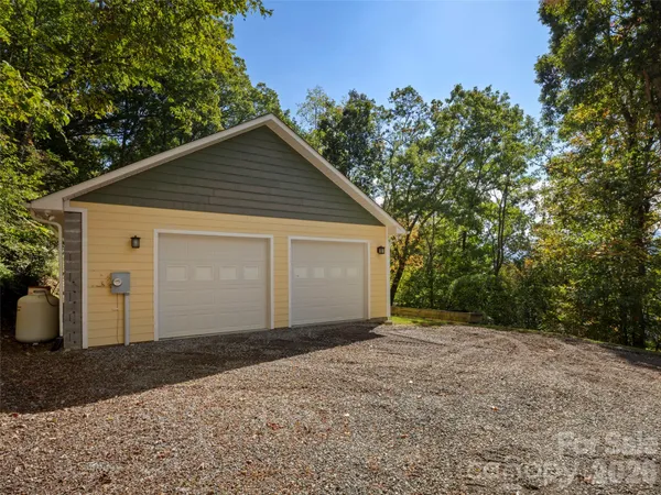 a view of a house with a yard and garage