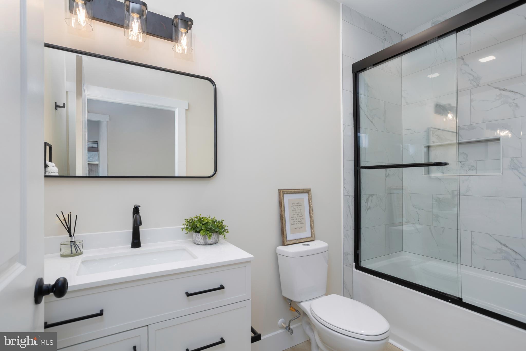 3 Sunrise Avenue Ridgely, MD 21660 - Photo 20 of 22 a bathroom with a sink a mirror a toilet and shower