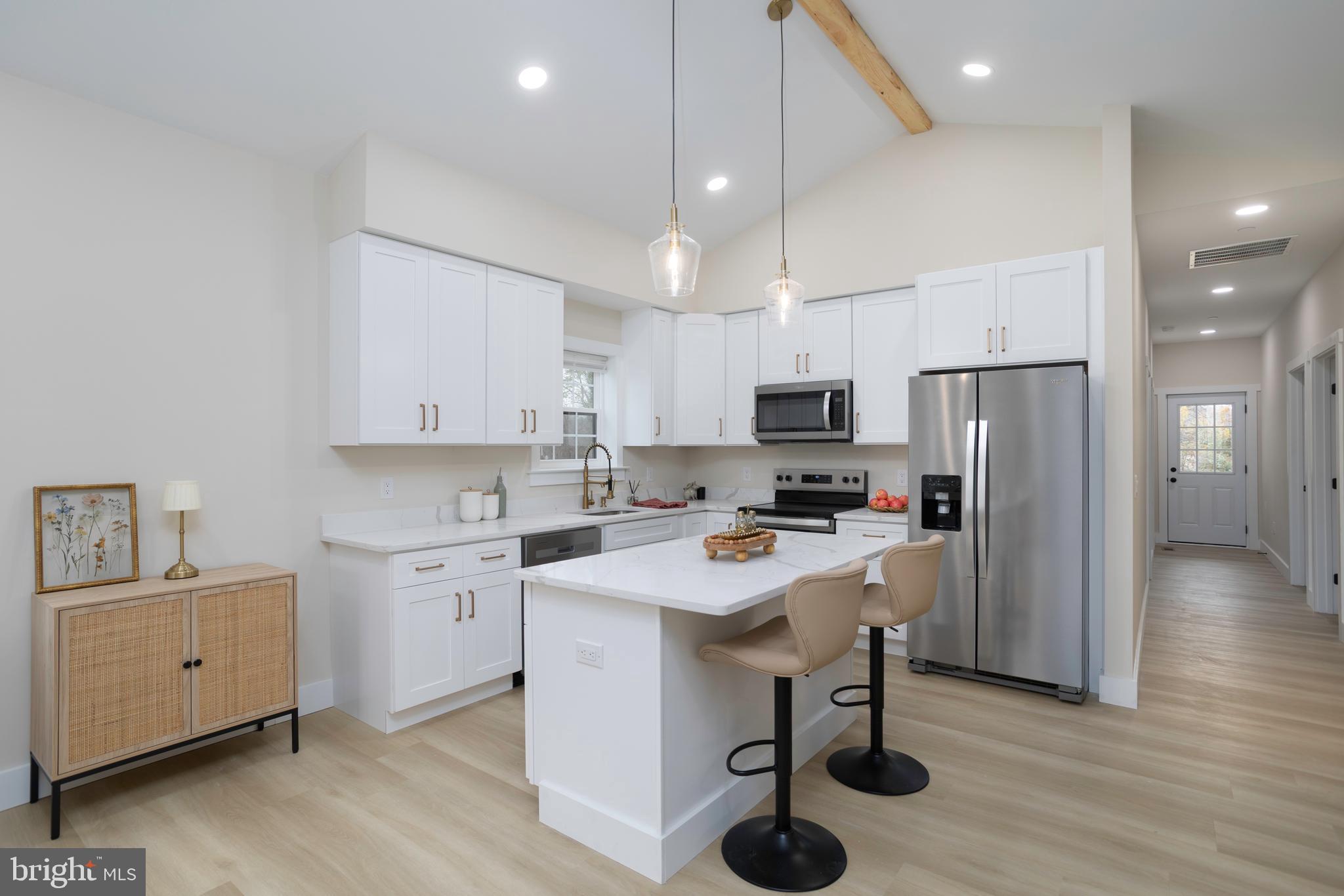 3 Sunrise Avenue Ridgely, MD 21660 - Photo 9 of 22 a kitchen with a refrigerator a sink dishwasher and a stove with wooden floor