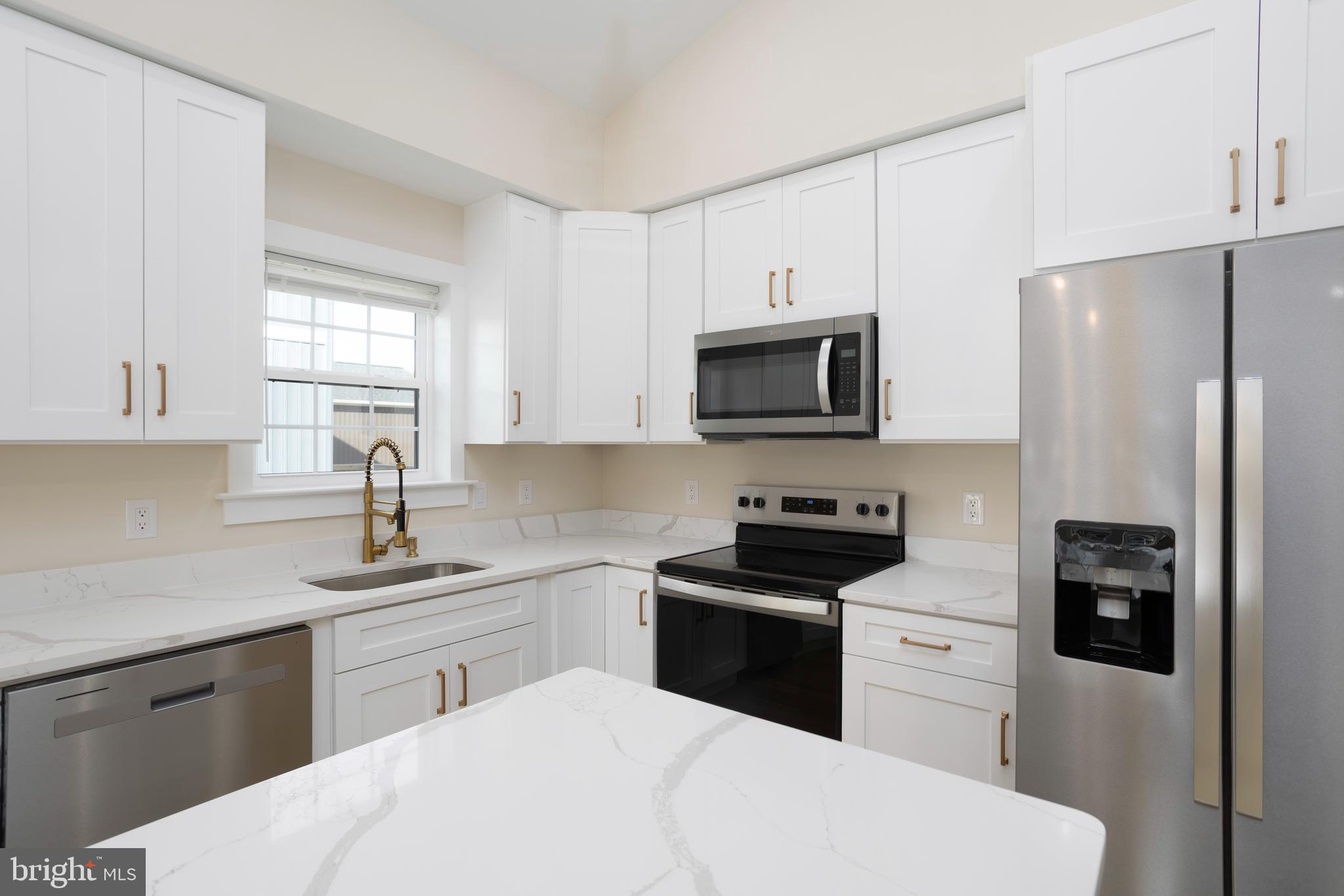 3 Sunrise Avenue Ridgely, MD 21660 - Photo 10 of 22 a kitchen with a sink stove and refrigerator