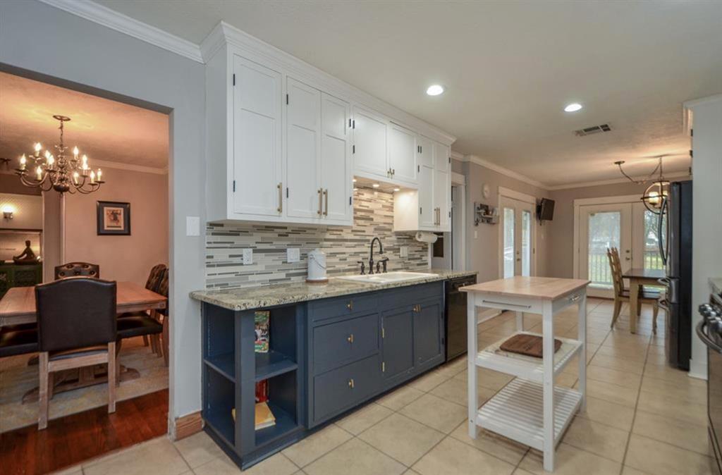 a view of a kitchen with kitchen island granite countertop wooden cabinets and counter space