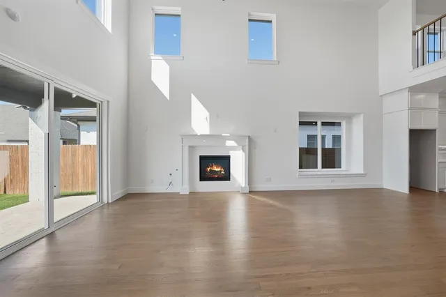 a view of an empty room with window and fireplace
