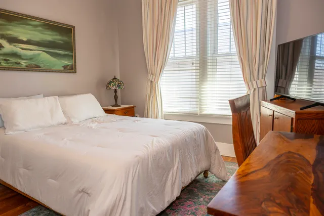 a bedroom with bed and window