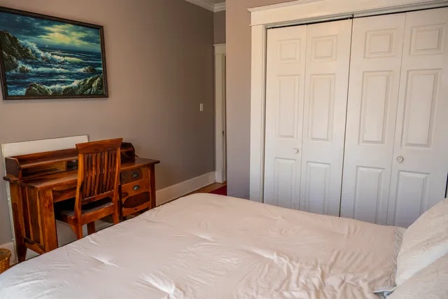 a bedroom with a bed and a closet