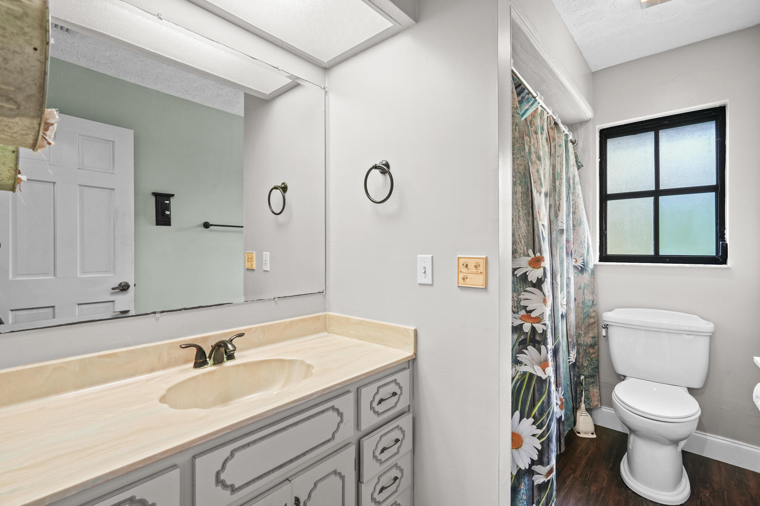 4170 McCarty Road Fort Pierce, FL 34945 - Photo 29 of 57 a bathroom with a granite countertop sink toilet and mirror