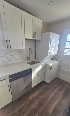 a kitchen with granite countertop white cabinets and white appliances