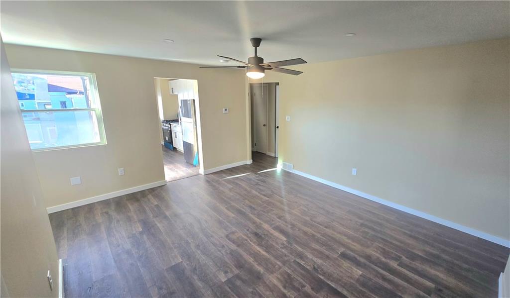 4560 Friendship Avenue Pittsburgh, PA 15224 - Photo 4 of 20 wooden floor in an empty room with a window