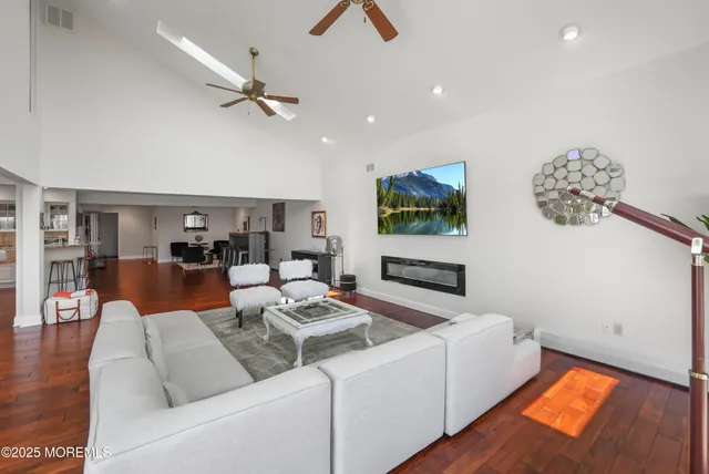 a view of a hallway with wooden floor and stairs