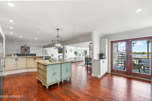 a spacious bedroom with a bed and a flat screen tv