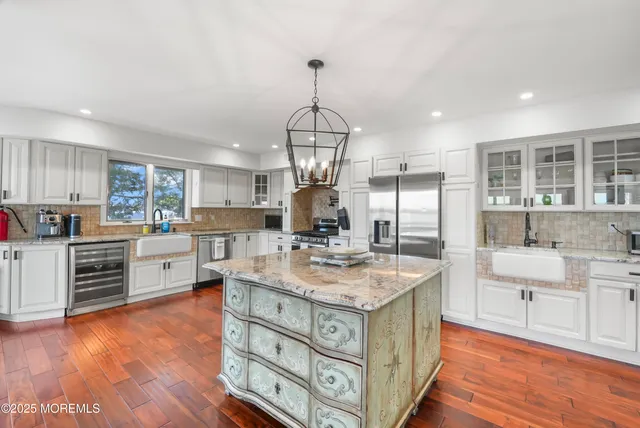 a bedroom with a large bed and a flat tv screen on dresser