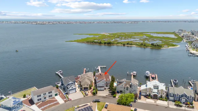 a living room with furniture a flat screen tv and a large window