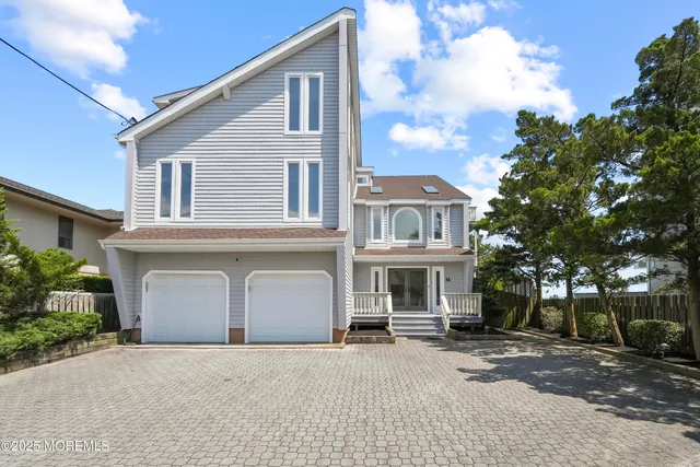 a living room with lots of furniture wooden floor and a fireplace