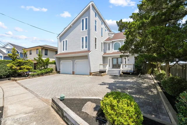 a living room with furniture kitchen view and a wooden floor