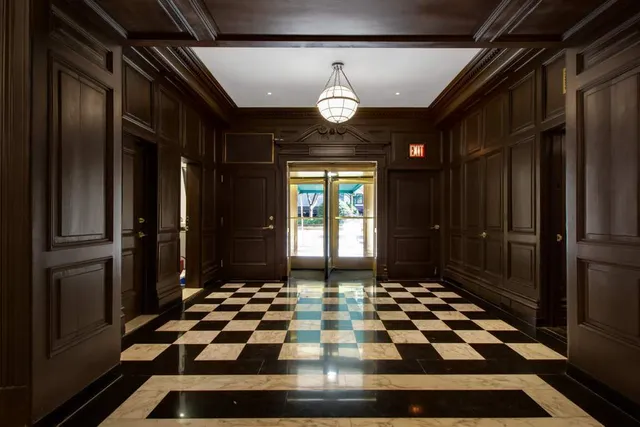 a living room with furniture a fireplace and a potted plant