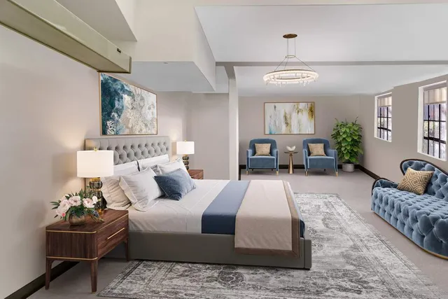 a bedroom with double bed furniture and a chandelier