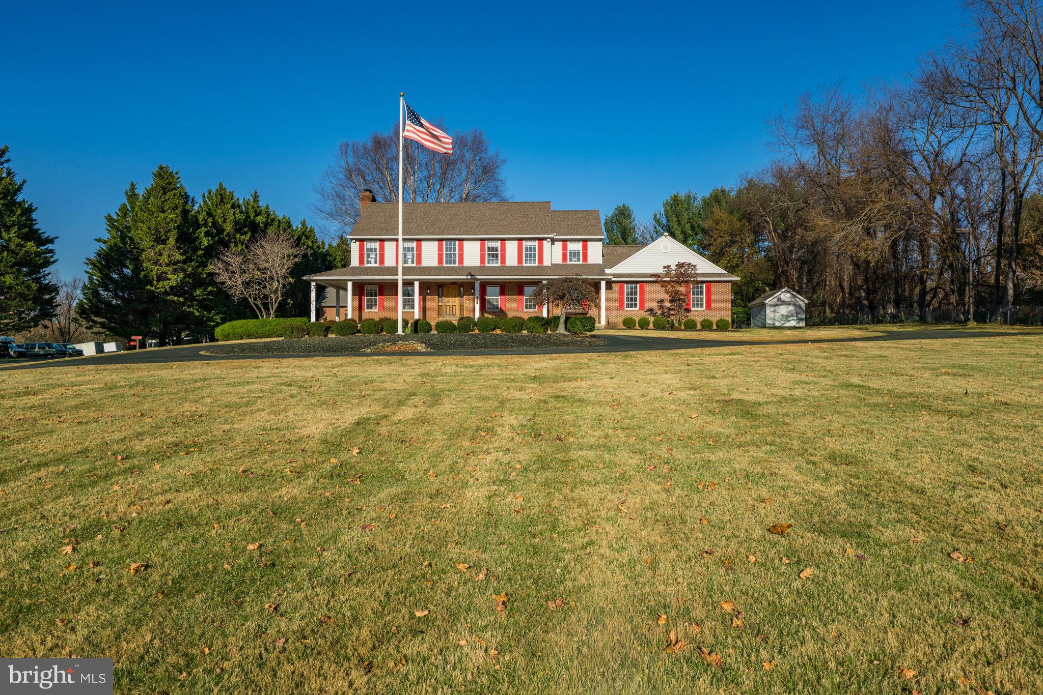 a front view of a house with a big yard