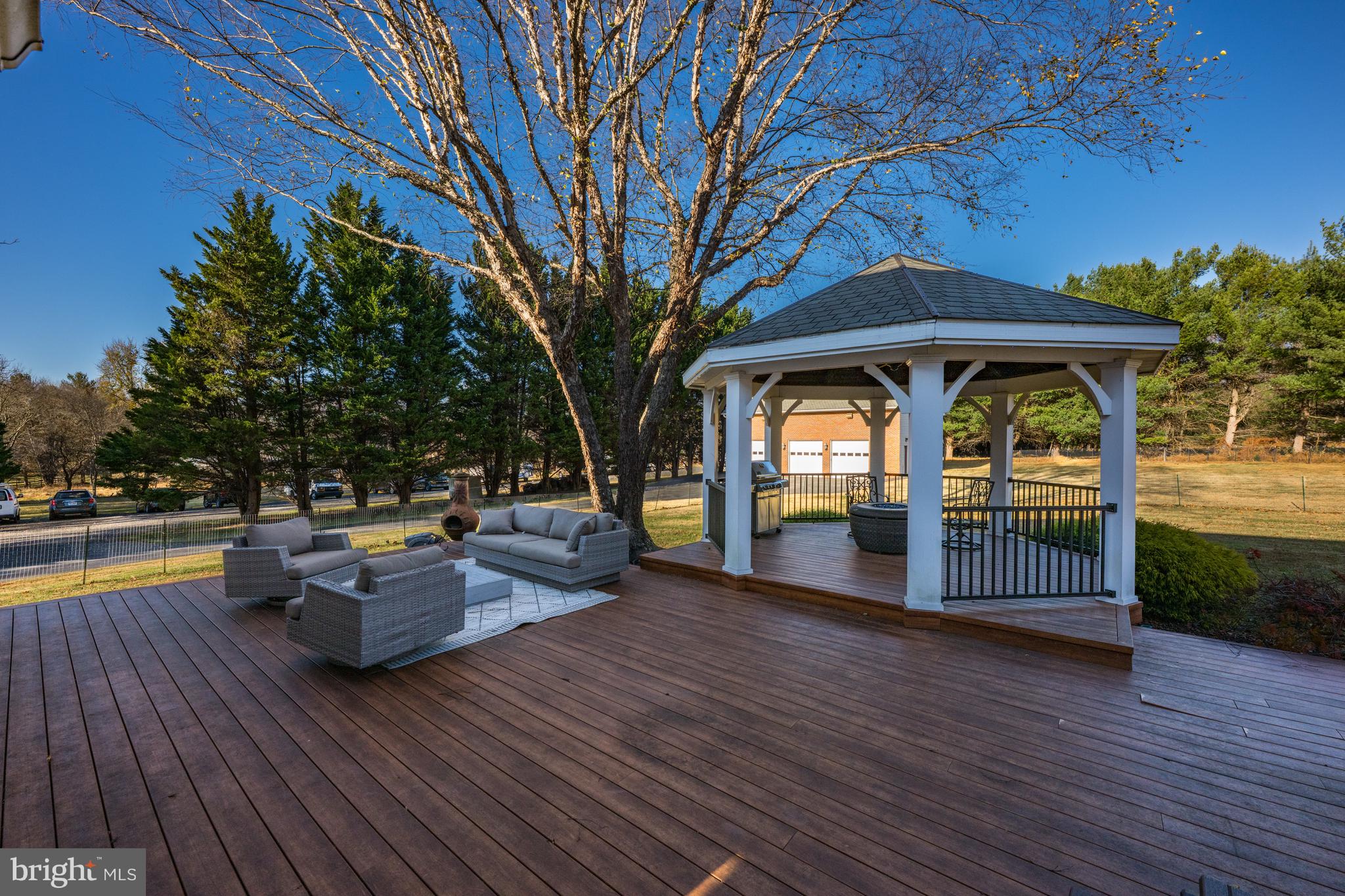 4807 Bready Road Rockville, MD 20853 - Photo 16 of 44 a view of patio with couches and table and chairs with wooden floor and fence