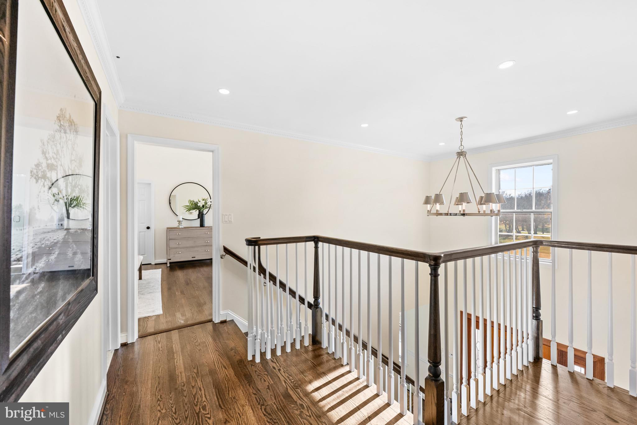 4807 Bready Road Rockville, MD 20853 - Photo 25 of 44 a view of staircase with railing and a chandelier