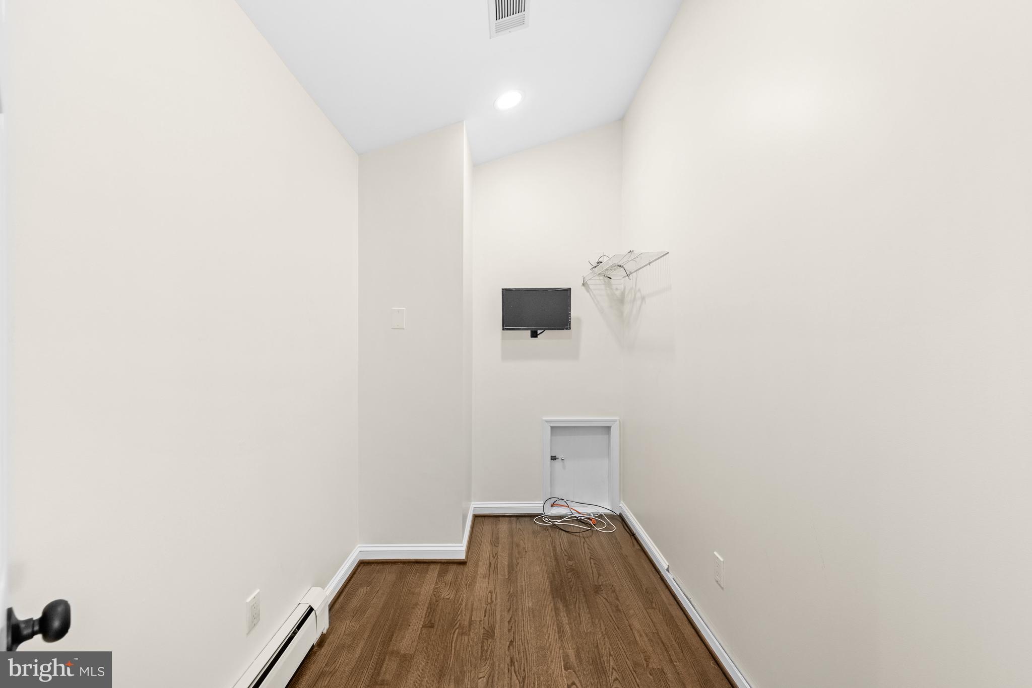 4807 Bready Road Rockville, MD 20853 - Photo 30 of 44 a view of a hallway with wooden floor and a potted plant
