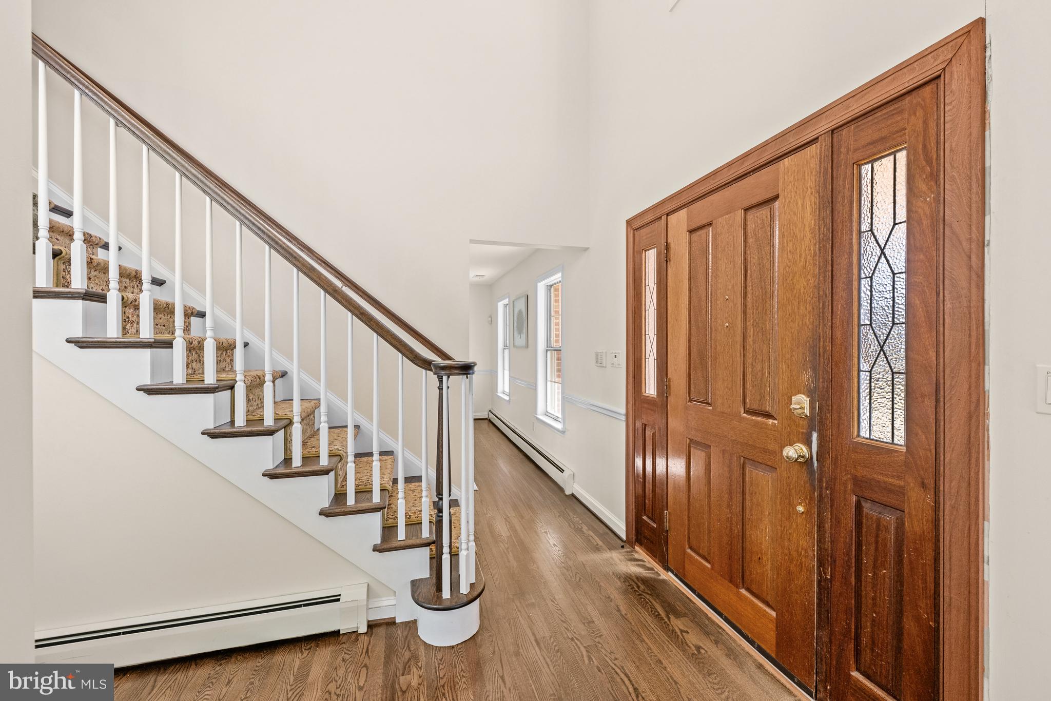 4807 Bready Road Rockville, MD 20853 - Photo 6 of 44 a view of staircase with lots of frames on wall and wooden floor